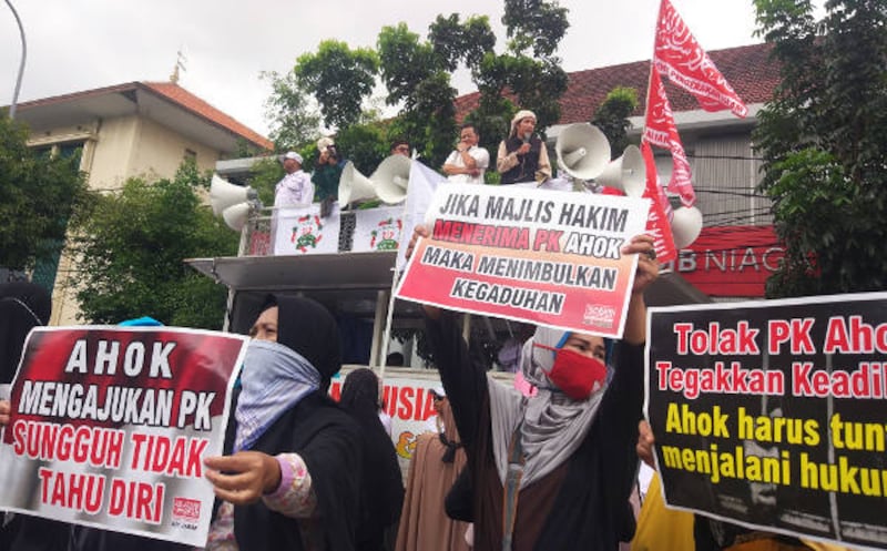 Massa penentang Ahok membawa poster dan berorasi di luar Pengadilan Negeri Jakarta Utara, 26 Februari 2018. (Rina Chadijah/BeritaBenar)