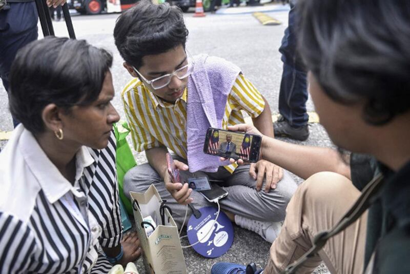 Journalists in Kuala Lumpur use their mobile phones to watch interim Prime Minister address the nation, Feb. 26, 2020. [S. Mahfuz/BenarNews]