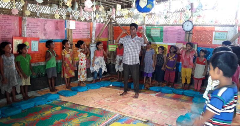 কক্সবাজারের উখিয়ার একটি শরণার্থী শিবিরে অনানুষ্ঠানিক শিক্ষা কেন্দ্রে রোহিঙ্গা শিশুদের পাঠদান করছেন শিক্ষক। ১২ সেপ্টেম্বর ২০১৯।