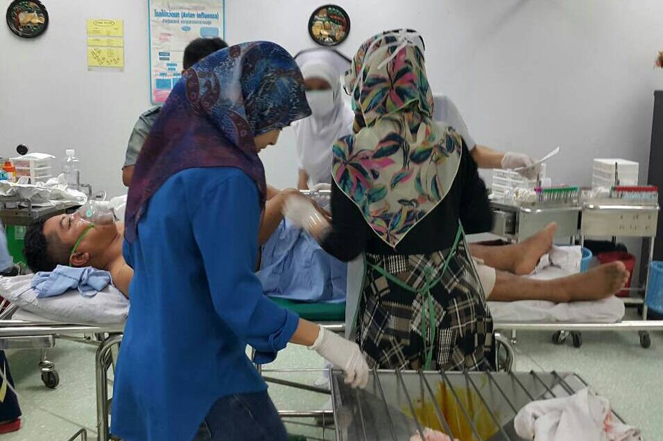 Nurses in a hospital in Pattani, Thailand treat Lance Cpl. Thanee Somrup, who was injured in a bomb attack, March, 17, 2015.