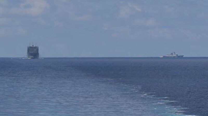 A photo taken from the littoral combat ship USS Montgomery, shows the USNS Cesar Chavez (left) and a Chinese Navy warship, May 7, 2020. [Courtesy U.S. Navy]