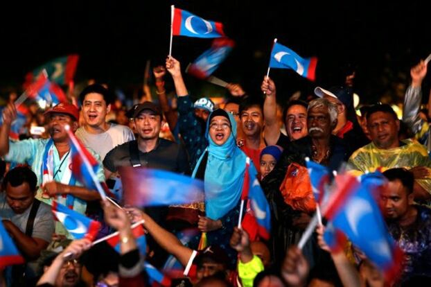 Penyokong-penyokong bekas pemimpin Malaysia, Anwar Ibrahim, melaungkan slogan semasa perhimpunan pilihan raya di Kuala Lumpur, 6 Mei 2018.
