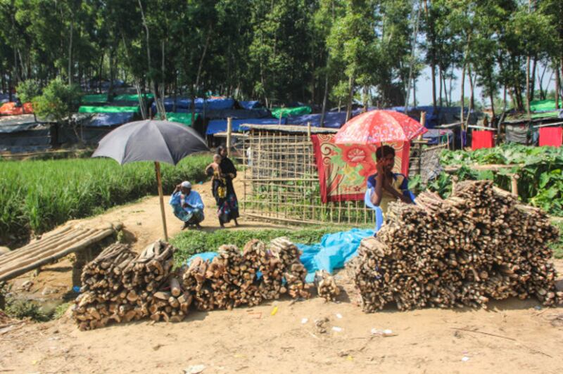 A Rohingya boy who sells wood waits for customers near the Kutupalong refugee camp in Cox's Bazar, Bangladesh, Oct. 30, 2017. (Rohit Wadhwaney/BenarNews)