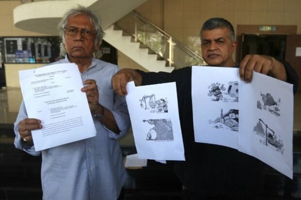 Peguam Cecil Rajendran (kiri) bersama kartunis Zunar di Mahkamah Tinggi Pulau Pinang selepas memfailkan saman terhadap kerajaan Malaysia dan Polis DiRaja Malaysia, Pulau Pinang, 12 November, 2018.