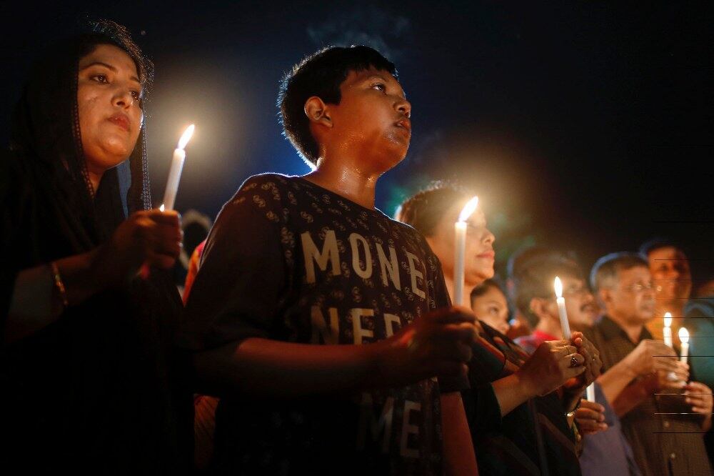 People light candles as they pay tribute to victims of a terrorist attack at the Holey Artisan Bakery café in Dhaka, July 3, 2016.