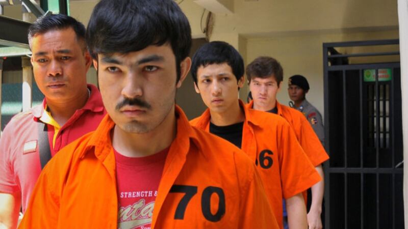 Three Uyghur detainees arrested in Poso Regency in 2014 walk to the court room in Jakarta ahead of their verdicts on terrorism charges, July 13, 2015. (AFP)