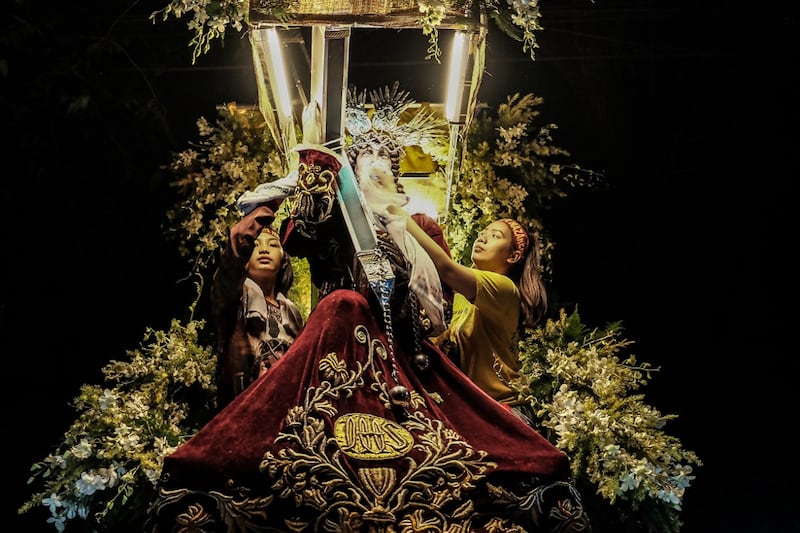 Women devotees prepare the statue of the Black Nazarene for an annual procession in the heart of downtown Manila, Jan. 9, 2019. [Karl Romano/BenarNews]