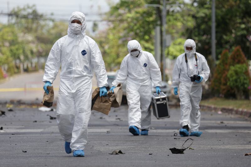 Police investigators arrive at the wreckage of car bomb following an explosion outside the Southern Border Province Administration office in Yala March 17, 2020.(AFP)