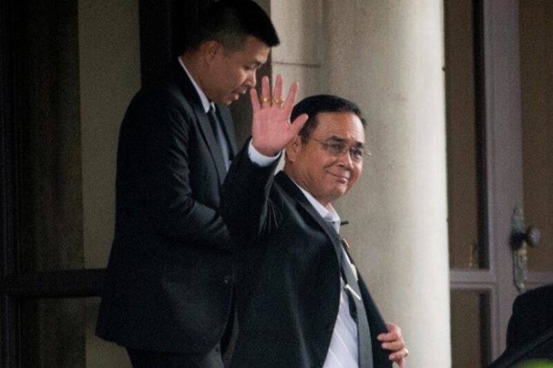 Thai junta chief Prayuth Chan-o-cha waves to photographers before leaving government house in Bangkok, June 5, 2019. [AP]