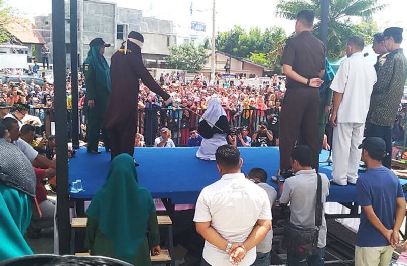 Ratusan warga menyaksikan pelaksanaan eksekusi cambuk di halaman sebuah masjid di Banda Aceh, 20 April 2018. (Nurdin Hasan/BeritaBenar)