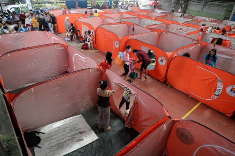 Residents occupy an evacuation center as rains from a typhoon locally known as Rolly start to pour in Manila, Philippines, Sunday, Nov. 1, 2020 (AP)
