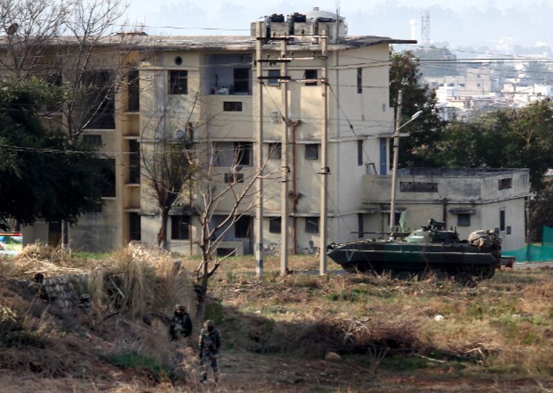 Indian Army soldiers take positions outside the residential quarters on the second day of a militant attack at Sunjuwan army camp in Jammu, Feb. 11, 2018.