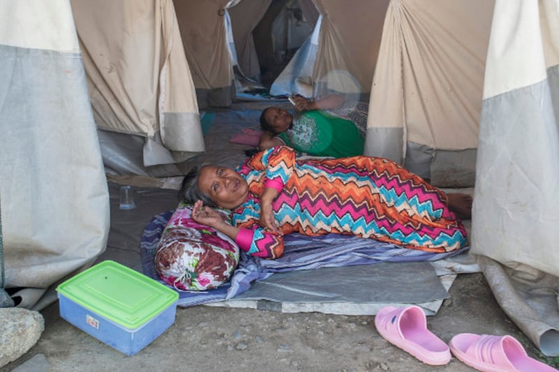 Nurlina (front) and a fellow survivor of the 2018 earthquake and tsunami rest in their tents in Palu, Indonesia, Sept. 22, 2019. [Keisyah Aprilia/Benarnews]