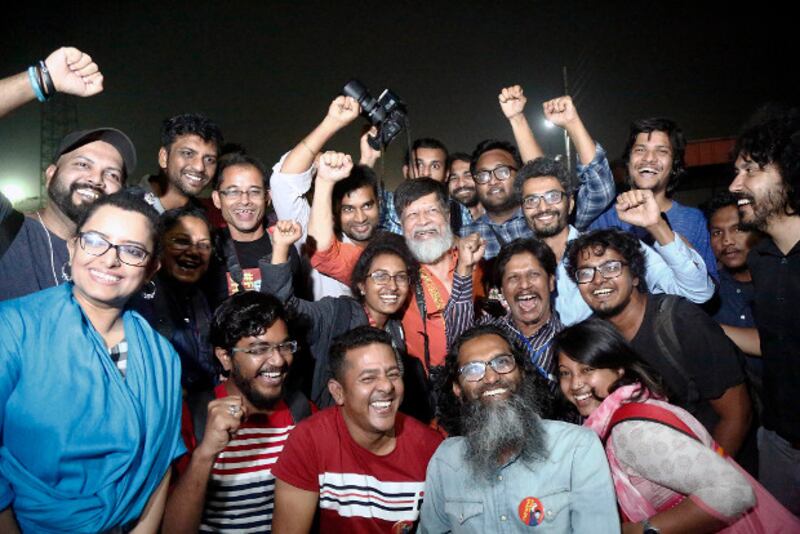 Supporters and friends cheer after Bangladeshi photojournalist Shahidul Alam received his temporary freedom and walked out of the Dhaka Central Jail, Nov. 20, 2018.