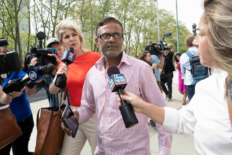 Reporters surround the father of suspect Ashiqul Alam as he leaves federal court in Brooklyn, N.Y., June 7, 2019. [AP]