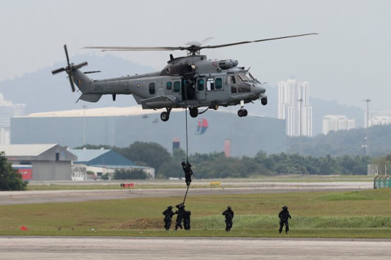Special Forces demonstrate skills during a drill in combatting terrorism from a helicopter after the launching of joint patrols between Malaysia, Indonesia and Philippine at the Subang military airbase in Petaling Jaya, Malaysia, Oct. 12, 2017.