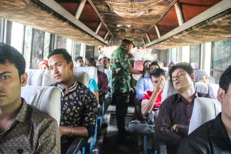 A member of the Bangladeshi security forces carries out a check on a bus to identify Rohingya refugees in Cox's Bazar, Bangladesh, Oct. 29, 2017. (Rohit Wadhwaney/BenarNews)