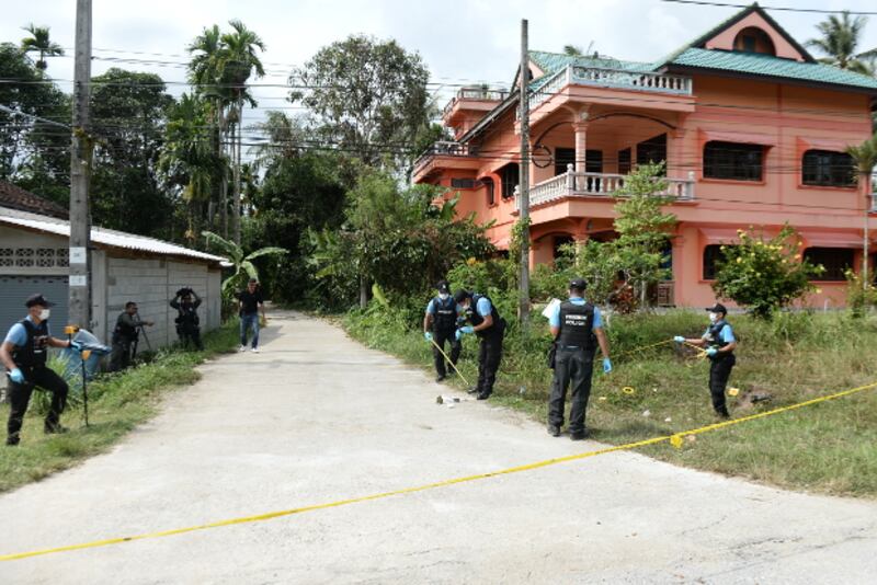 Thai police inspect the site of a drive-by shooting that killed a woman and her daughter in Bacho, a district of Narathiwat province in Thailand's insurgency-stricken Deep South, Aug. 11, 2018.