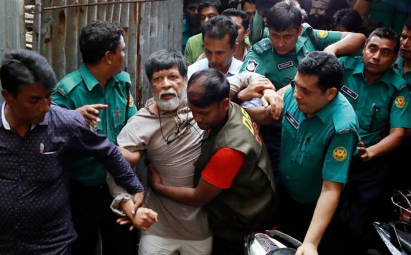 Officers move photographer Shahidul Alam to a Dhaka court where a judge allowed a seven-day remand for police to question him regarding statements about the student protests, Aug. 6, 2018.