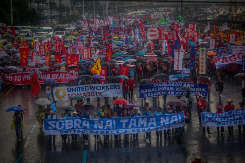 Thousands braved heavy rain to protest on the streets of Manila as President Rodrigo Duterte delivered his annual state of the nation address to congress, July 22, 2019. [Luis Liwanag/BenarNews]