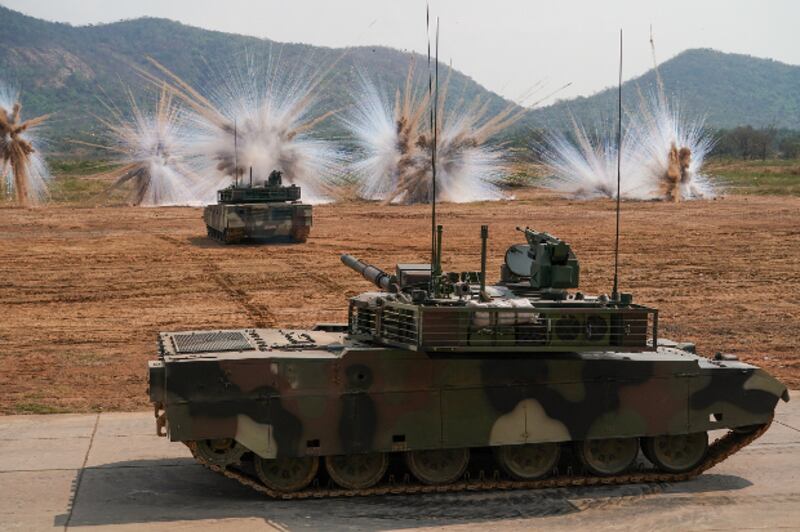 Thailand's Chinese-made VT-4 tanks fire smoke grenades to counter against laser target locks from other weapons during a demonstration in Saraburi province, Jan. 26, 2018. (Pimuk Rakkanam/BenarNews)