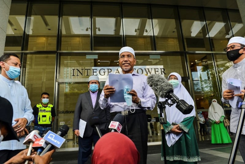 PAS vice president Idris Ahmad speaks to the media in front of the Integrate Tower in Kuala Lumpur, where the French Embassy is located, Oct. 27, 2020. 