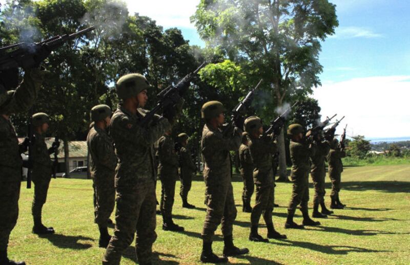 A Philippine Army platoon renders a gun salute as a sign of respect during the wreath-laying ceremony at the heroes' landmark inside the 103rd Infantry Brigade headquarters in Marawi, Oct. 17, 2019. [Richel V. Umel/BenarNews]