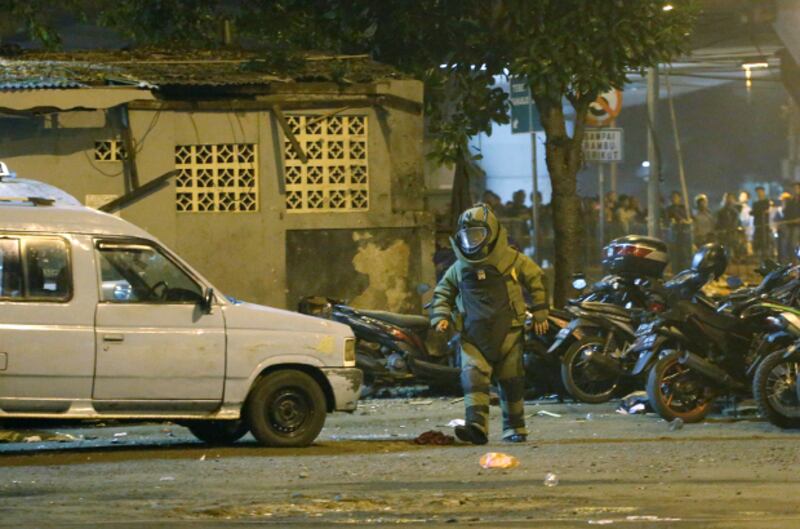A member of the police bomb squad inspects the site of an explosion in East Jakarta, May 24, 2017.