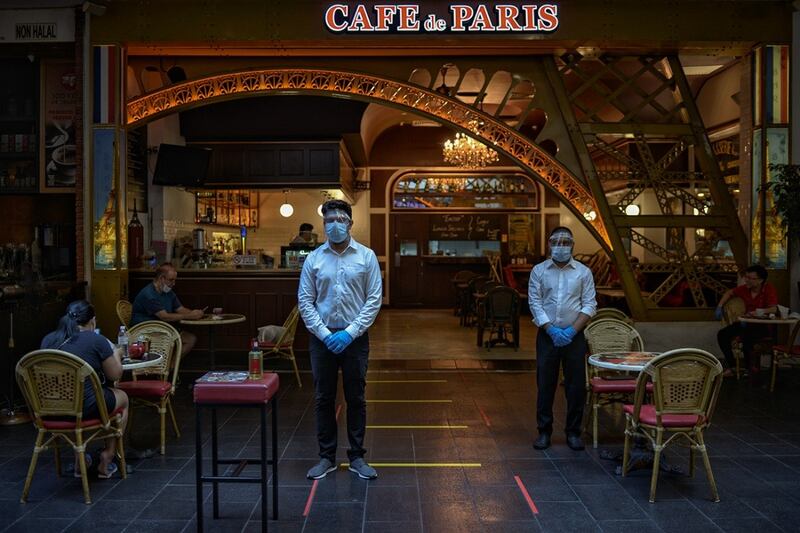 Restaurant workers wait for customers in Kuala Lumpur after the government allowed most businesses to re-open, May 4, 2020. [BenarNews/S.Mahfuz]