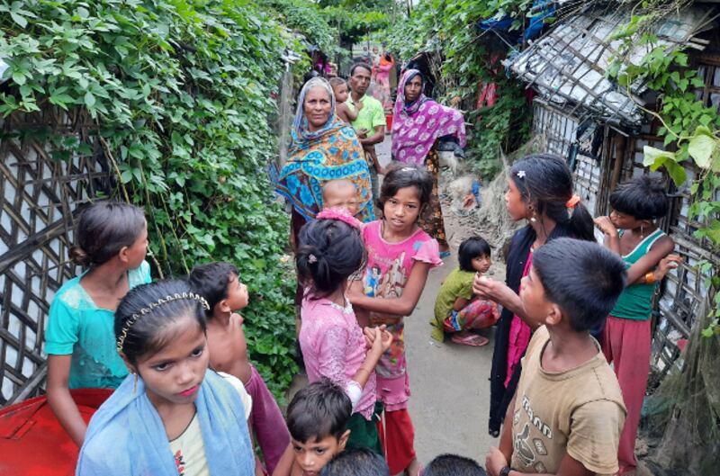 Rohingya women and children stand outside their homes in the Baharchara refugee camp in Teknaf in Cox's Bazar, Bangladesh, Aug. 16, 2020. [Sunil Barua/BenarNews]
