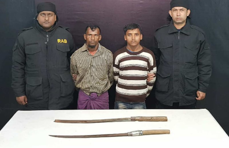 Rapid Action Battalion (RAB) personnel present Rohingya suspects Nur Mohammad, 30, and Ataur Rahman, 16, who allegedly confessed to killing a Rohingya camp leader because he supported refugee repatriation to Myanmar. 