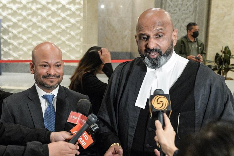 Attorney N. Sivananthan (right), joined by his client, Arul Kanda Kandasamy