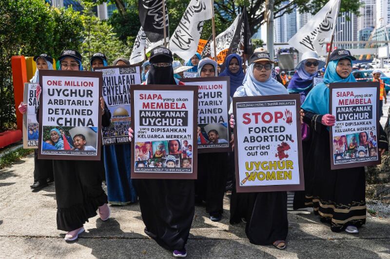 Malaysian demonstrators carry signs criticizing the detention of Uyghurs in China's Xinjiang region, during a protest rally outside the Chinese embassy in Kuala Lumpur, Dec. 27, 2019. [S. Mahfuz/BenarNews]