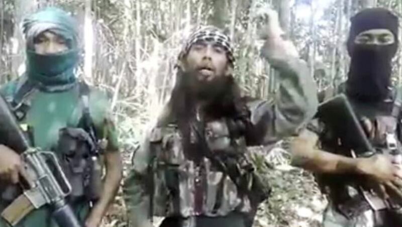 This still photo taken from a social media video shows MIT chief Ali Kalora (center), calling on his members to keep fighting. [Keisyah Aprilia]
