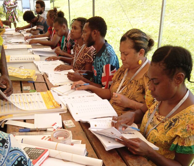 Electoral officers verifying voters identity.jpeg