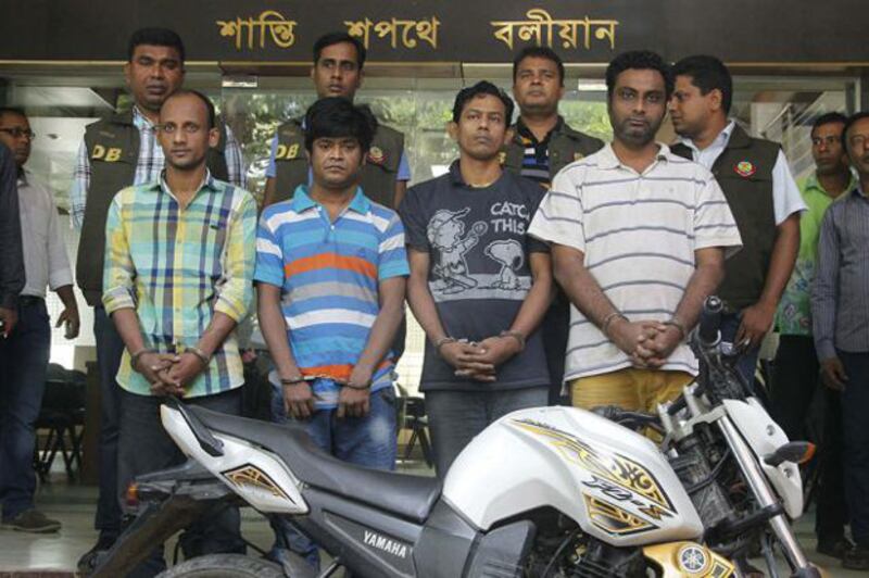 Four suspects (front row) in the murder of Italian aid worker Cesare Tavella are paraded before reporters outside Dhaka Metropolitan Police headquarters, Oct. 26, 2015.