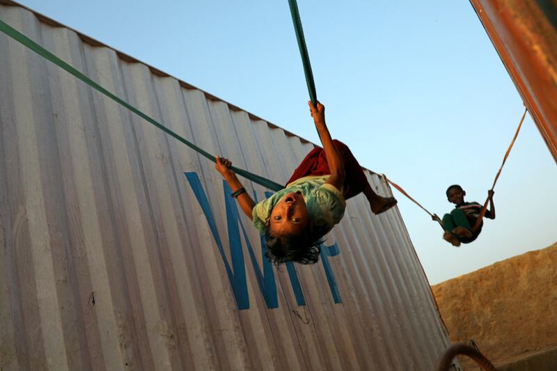 Rohingya refugee children play with a swing at the Balukhali camp in Cox's Bazar, Bangladesh, Nov. 16, 2018. [Reuters]
