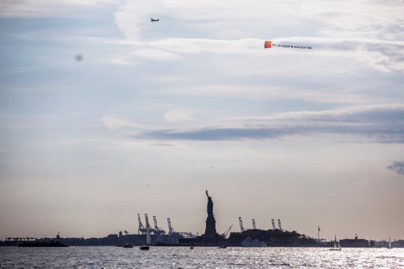 A plane towing a banner calling for Shahidul Alam to be freed in Bangladesh flies over the Statue of Liberty in New York, Sept. 30, 2018. (Photo courtesy of Wasfia Nazreen)