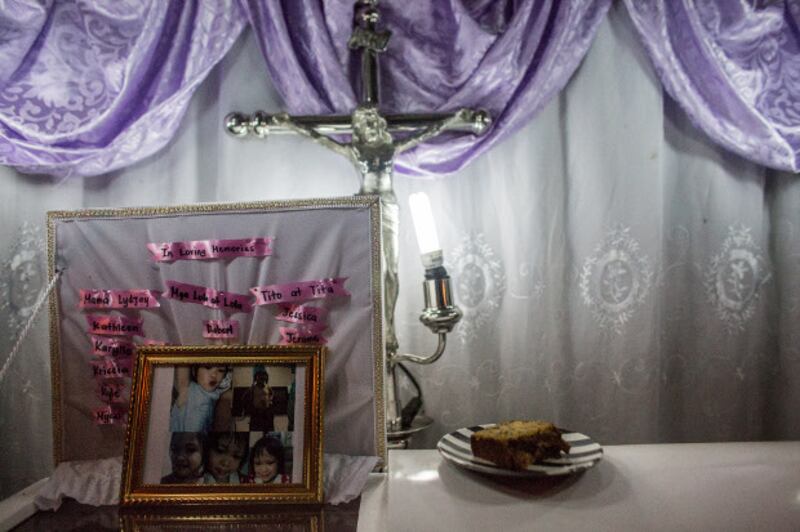 Photos of Myca Ulpina, a 3-year-old Filipina who was killed by gunfire during a police counter-narcotics operation, are seen during her wake in Rizal province, Philippines, July 5, 2019. [Basilio Sepe/BenarNews]
