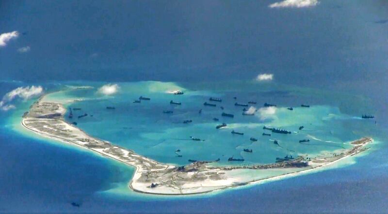 Chinese dredging ships are seen around Mischief Reef in the disputed Spratly Islands in the South China Sea in this image from a U.S. Navy surveillance aircraft, May 21, 2015. (U.S. Navy handout via Reuters)