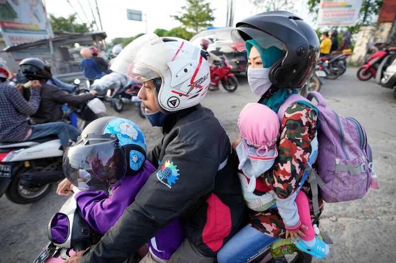 Satu keluarga mengendarai sepeda motor saat mereka menuju ke kampung halaman mereka di Cikarang, Jawa Barat, 29 April 2022. Mudik tahun ini bisa dilakukan tanpa pembatasan setelah dua tahun sebelumnya tidak bisa dilakukan dengan bebas karena pandemi COVID-19. [AP ]