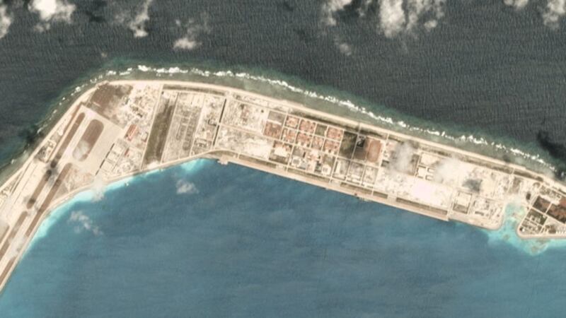A satellite image taken March 19, 2020, over the Chinese-occupied base at Mischief Reef, showing a large vessel at the quayside. Ship-tracking software shows that Chinese Coastguard ship 5302 stopped there that day. [Planet Labs Inc.]