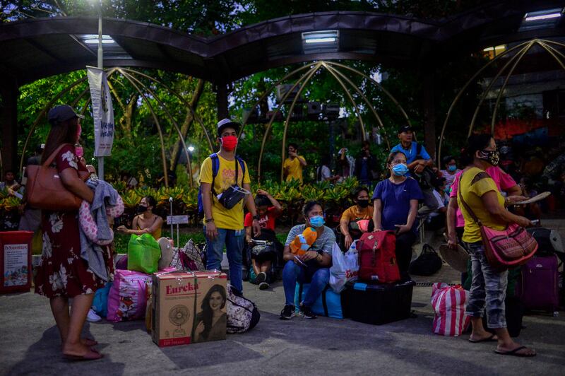 Filipinos wait at the Redemptorist Church in Manila for free bus rides to the eastern province of Albay, June 5, 2020. [Czar Dancel/BenarNews] 