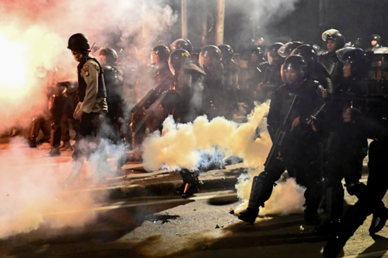 Police armed with riot shields shot tear gas at stone-throwing protesters at Tanah Abang in Central Jakarta in the middle of the night, after groups of protesters refused to disperse. (AFP)