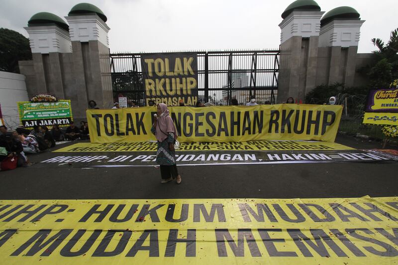 Seorang aktivis berpidato dalam unjuk rasa menentang pengesahan Rancangan Kitab Undang-Undang Hukum Pidana (RKUHP) yang dinilai mengandung pasal kontroversial terkait intervensi negara terhadap kehidupan privat masyarakat dan kriminalisasi atas kebebasan berpendapat, di depan Gedung DPR, di Jakarta, 5 Desember 2022. [Eko Siswono Toyudho/BenarNews]