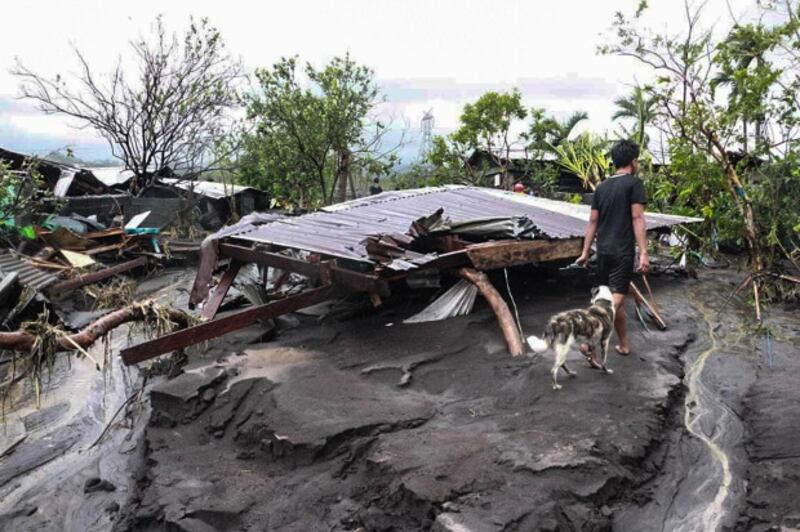 A resident wanders around houses destroyed by flashfloods due to Typhoon Goni in Albay province, southeast of Manila, Nov. 1, 2020. (BenarNews)