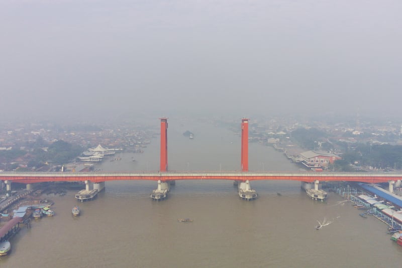 An aerial view shows the Ampera Bridge over the Musi River amid haze from an ongoing wildfire in Palembang, South Sumatra, on Sept. 14, 2023.