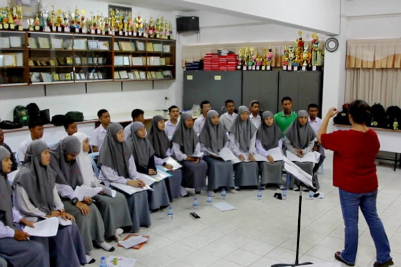 Members of the chorus at the Attarakeeyah Islamiyah School in Narathiwat, a province of Thailand's Deep South, rehearse before joining a university choir in Bangkok to perform songs of peace in front of Pope Francis, Nov. 19, 2019. [Matahari Ismail/BenarNews] 